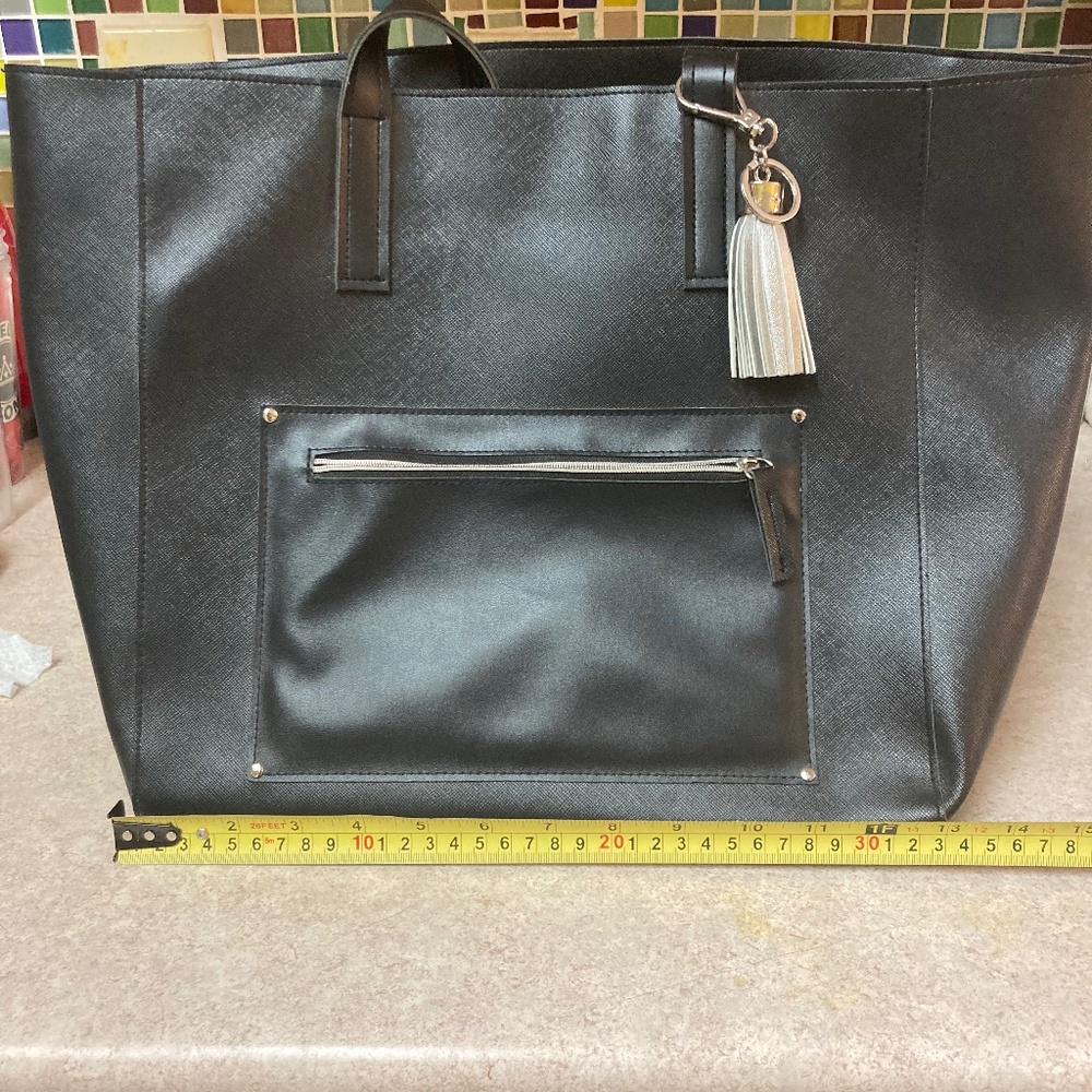 Women’s black faux leather tote with tassel